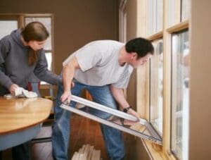 Man Installing Energy Efficient Windows in Home
