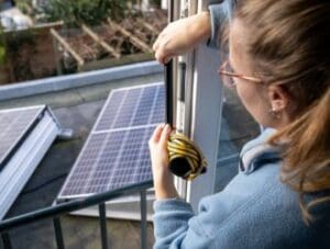 Woman Installing Weatherstrip Insulation to Front Door