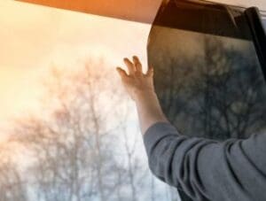 Man Covering Window with Insulating Film